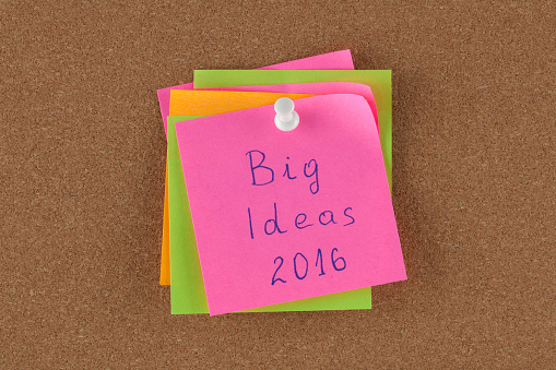 Color reminder note with pin on cork board big idea 2016.