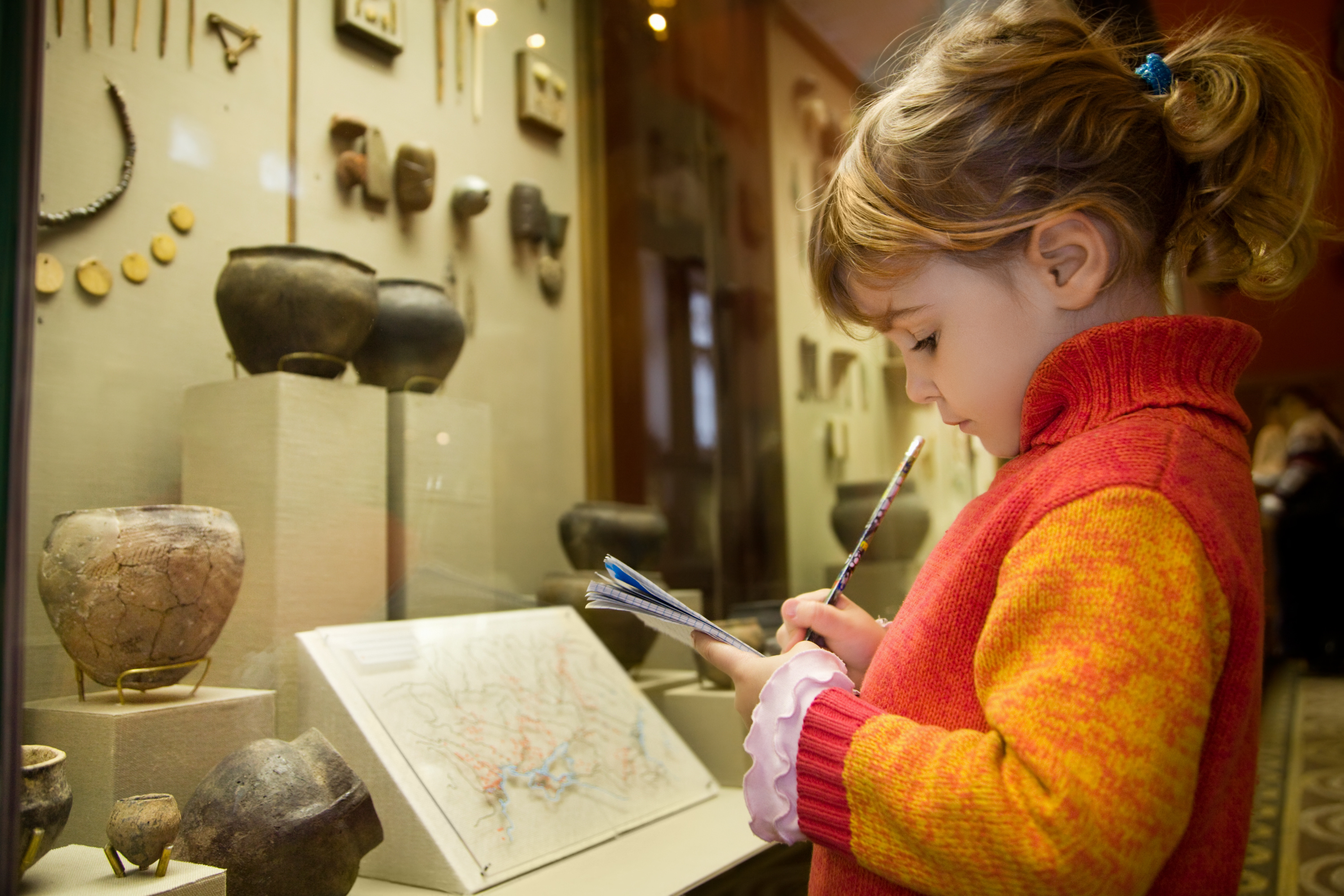 little-girl-writing-book-museum