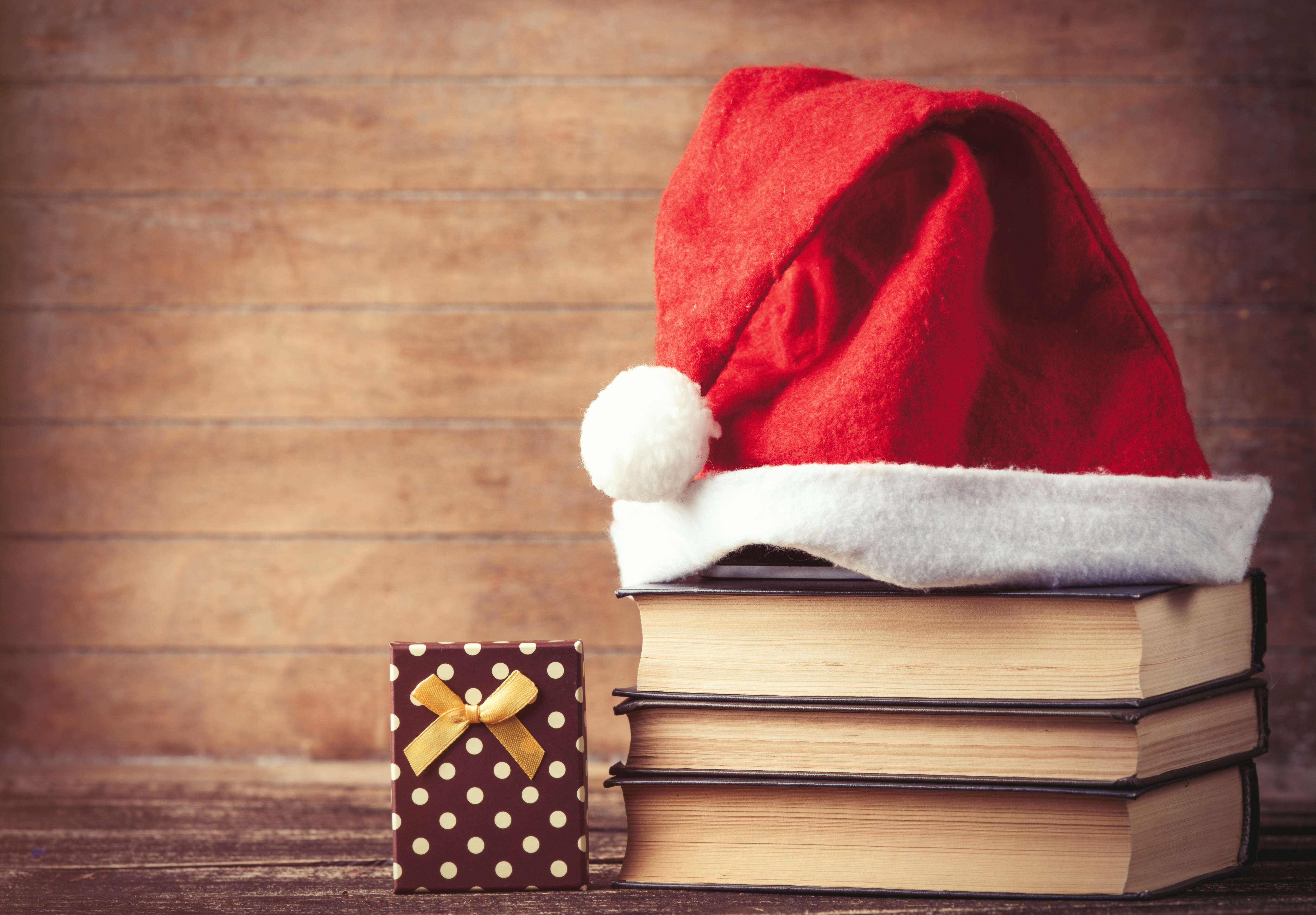 Santas-hat-over-books-near-gift-box