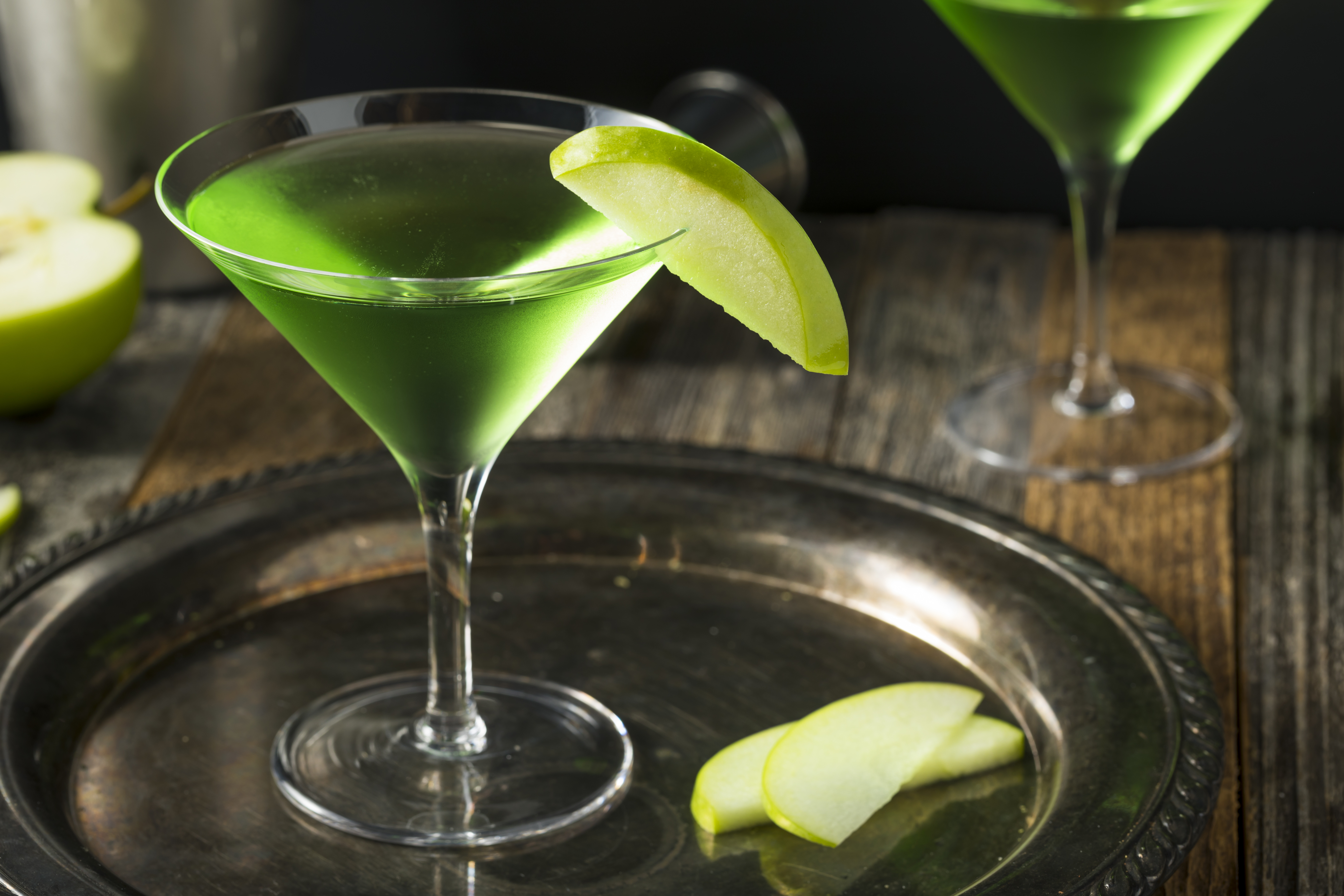 Homemade Green Alcoholic Appletini Cocktail with Apple Garnish