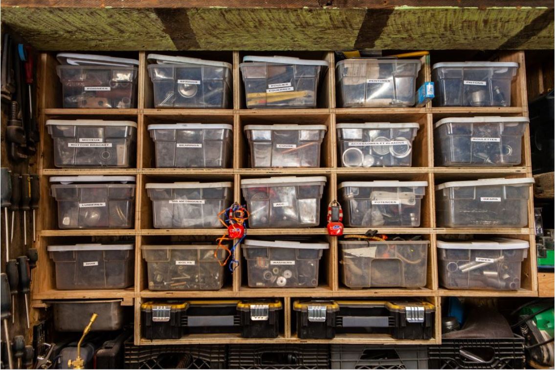 garage organization tips - clear bins in cubby shelves