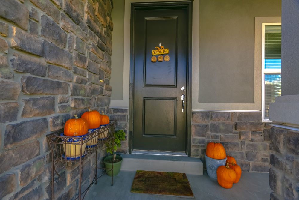 Fall Porch Ideas - pumpkins in flower pots
